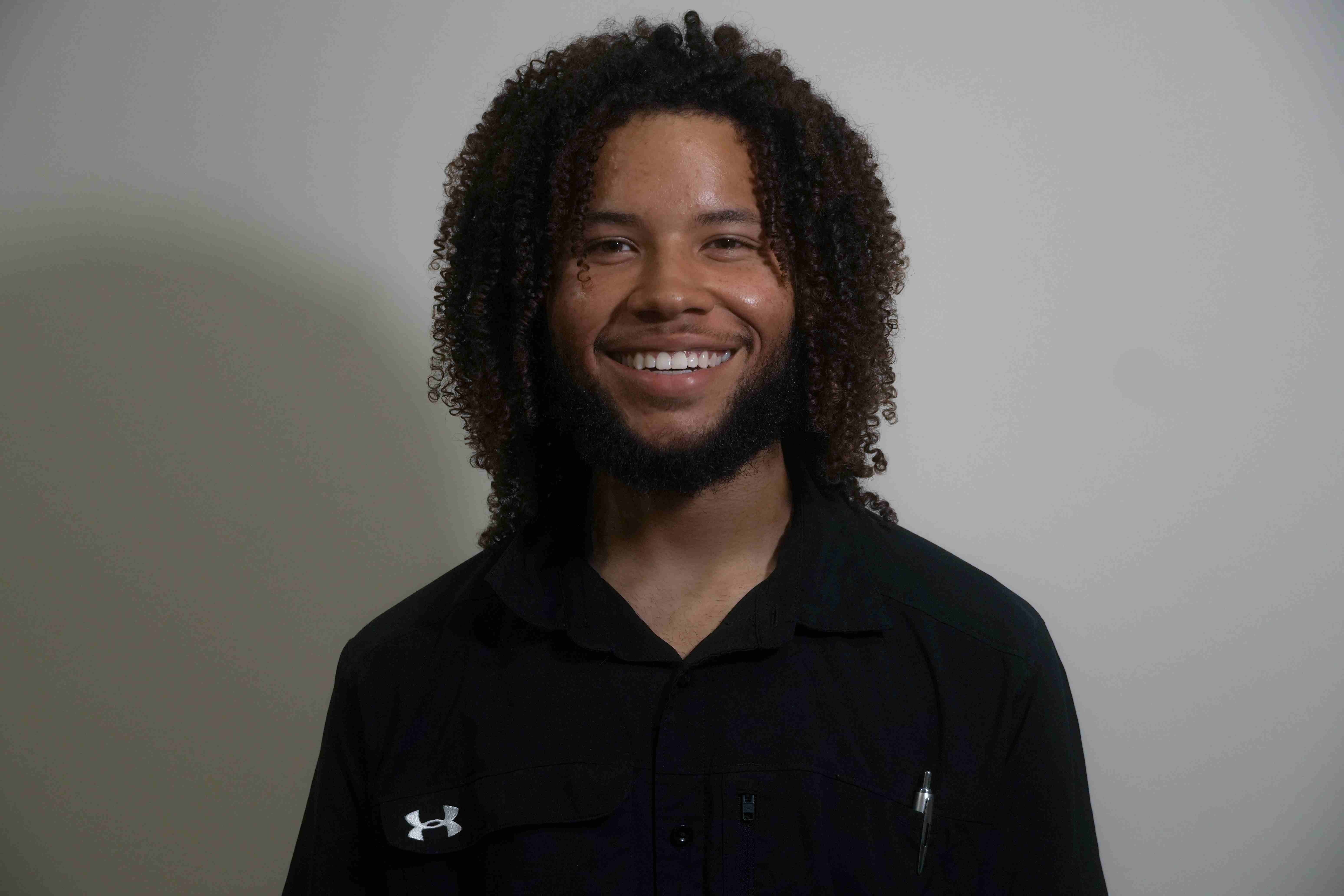 Shaun Mason, co-owner of Mason Mechanics, smiling in a black work shirt